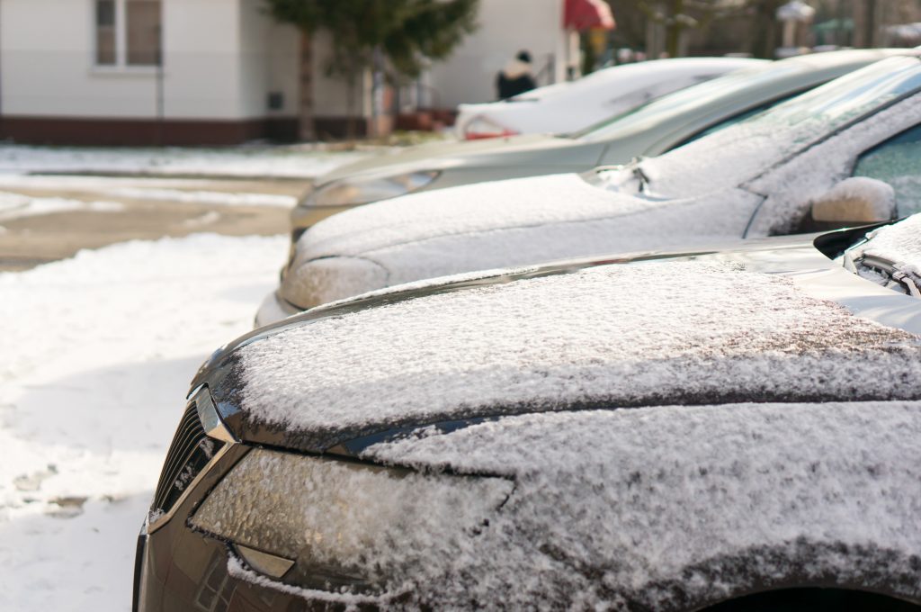 https://universalautocare.co/schedule-an-appointment Close up of a row parked cars covered with snow on a cold winter day.